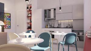a dining room with white tables and blue chairs at N'Agorà B&B in Naples