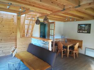a living room with a table and a wooden ceiling at Brunarica Lorentia in Bizeljsko