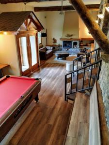 a living room with a pool table in a room at Hotel Roca in Alp