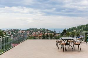 a patio with a table and chairs on a balcony at Terra Mia in Agerola