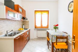a kitchen with a sink and a table with a tableablish at Terra Mia in Agerola