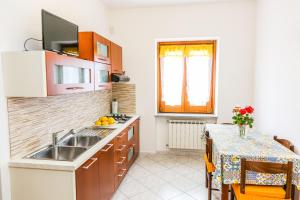 a kitchen with a sink and a table with a table cloth at Terra Mia in Agerola +43 photos
