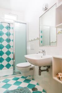 a bathroom with a sink and a toilet and a mirror at Terra Mia in Agerola