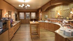 a large kitchen with wooden cabinets and a large island at Vilstaler Hof Landgasthof & Hotel in Rottersdorf