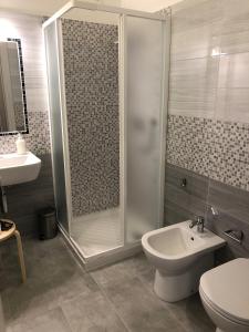 a bathroom with a shower and a toilet and a sink at Le camere della Nonna in Diano Marina +43 photos