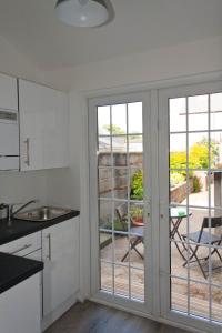 a kitchen with sliding glass doors with a view of a patio at 2 Minutes from Drumcondra Station in Dublin
