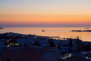 a view of the city at sunset at Sunset View Hotel in Parikia
