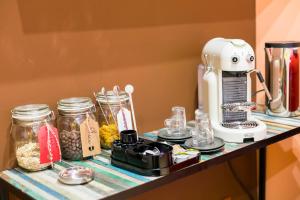 a kitchen counter with a mixer and jars of food at Appartamenti MarcoAurelio49 in Rome