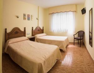Posteľ alebo postele v izbe v ubytovaní Hostal O Camouco