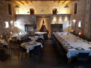 a large dining room with white tables and chairs at Regia Trazzera in Ragusa