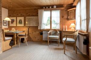 a room with a table and chairs in a wooden house at Casa Vesta Magnifica Wildi in Brigels
