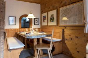 a dining room with a table and two chairs at Casa Vesta Magnifica Wildi in Brigels +20 photos
