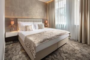Postel nebo postele na pokoji v ubytování Mamaison Residence Sulekova Bratislava + 37 fotografií