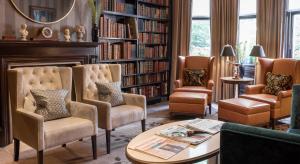 a library with chairs and a table and bookshelves at 11 Cadogan Gardens, The Apartments and The Chelsea Townhouse by Iconic Luxury Hotels in London