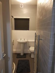 a bathroom with a white toilet and a sink at Highfields House - Free Wifi - Free Local Parking in Sheffield
