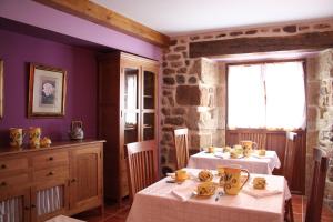 a dining room with two tables and a window at Posada El Arrabal in Arenas de Iguña