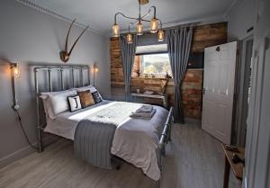 a bedroom with a bed and a window at James' Place at Dowlais in Merthyr Tydfil