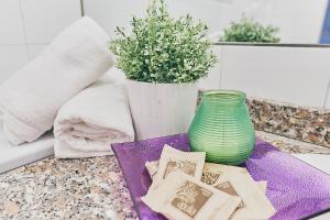 a table with a green vase and a purple plate at Lovelyloft - Ripa Naviglio Grande in Milan