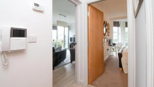 a hallway leading to a living room with a tv at Eleven in Deganwy