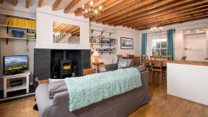 a living room with a couch and a fireplace at One Bron Derw in Dolwyddelan