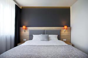 Postel nebo postele na pokoji v ubytování Elba Hotel