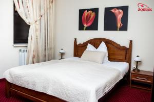 Postel nebo postele na pokoji v ubytování Hotel Zodiak