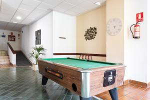 a pool table in the middle of a room at Tropic Apartments en Castle harbour in Los Cristianos