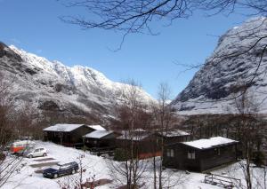 a snow covered mountain with a group of buildings at Beech Chalet in Glencoe