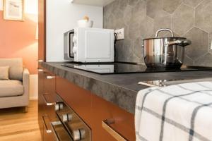 A kitchen or kitchenette at JOIVY Bright Apartment for 4 next to City Life