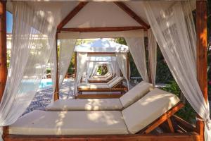 a bedroom with a canopy bed and a pool at Hotel Summery in Lixouri