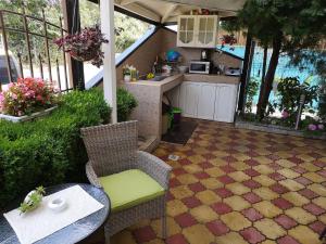 an outdoor kitchen with a table and chairs and a counter at Guest House Sv Nikola in Ahtopol