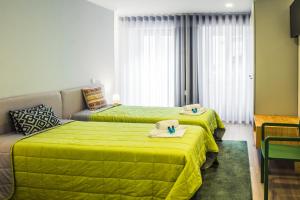 Ένα ή περισσότερα κρεβάτια σε δωμάτιο στο In Barcelos Hostel & Guest House