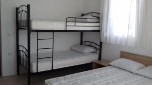 two bunk beds in a room with two beds at Apartments Vladimir in Agios Nikolaos