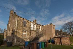 an old brick building with a spiral staircase on it at Brucefield Avenue in Dunfermline