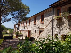 an external view of a stone building with trees at Tenuta Di Maro in Sticciano