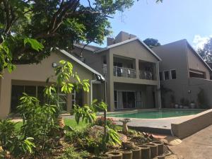 a house with a swimming pool in front of it at DeTlous BnB in Empangeni