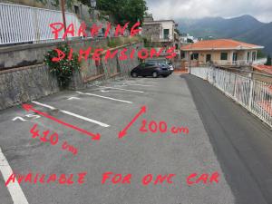 a car parked in a parking lot with the words parking dangerousamine for one car at Gala Residence Villa Giovanna in Ravello