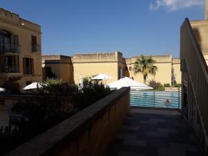 a swimming pool in the middle of a building at Poolside Luxury Apartment with Patio 11A4S in Mġarr