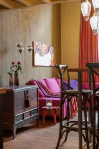 a living room with a couch and a table and chairs at Apartments Breydelhof in Bruges