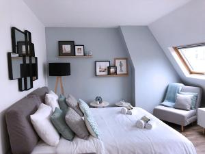 a bedroom with a bed and a couch and a chair at Dreamyflat - Champs Elysées in Paris