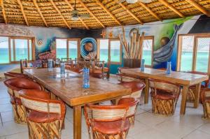 a dining room with wooden tables and chairs at Villa Paraíso in La Ventana