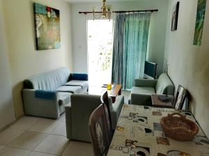 a living room with a couch and a table at Faneromeni Court in Paphos City