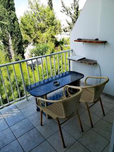 a blue table and two chairs on a balcony at Faneromeni Court in Paphos