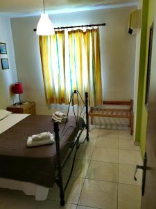 a bedroom with a bed and a window at Faneromeni Court in Paphos City