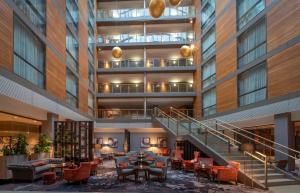 a view of the lobby of a building with tables and chairs at Clayton Hotel Cork City in Cork