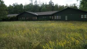 a house in the middle of a field of grass at Bredängs Hostel in Stockholm