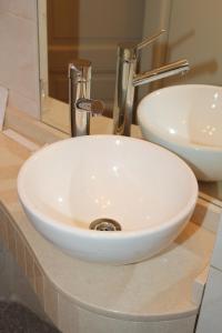 a white sink sitting on a counter in a bathroom at Ayacucho Palace Hotel in Buenos Aires