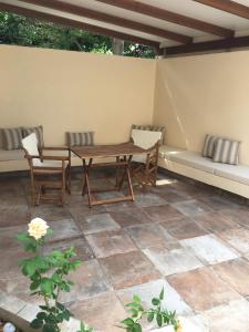 a patio with a table and chairs and a couch at Luxury studio in the centre of Palaikastro in Palekastron