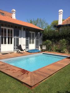 a swimming pool in the yard of a house at Villa Madelon in Arcachon