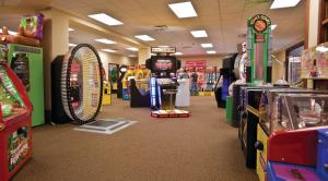 a store aisle with arcade games and prizes at Club Wyndham Glacier Canyon in Lake Delton